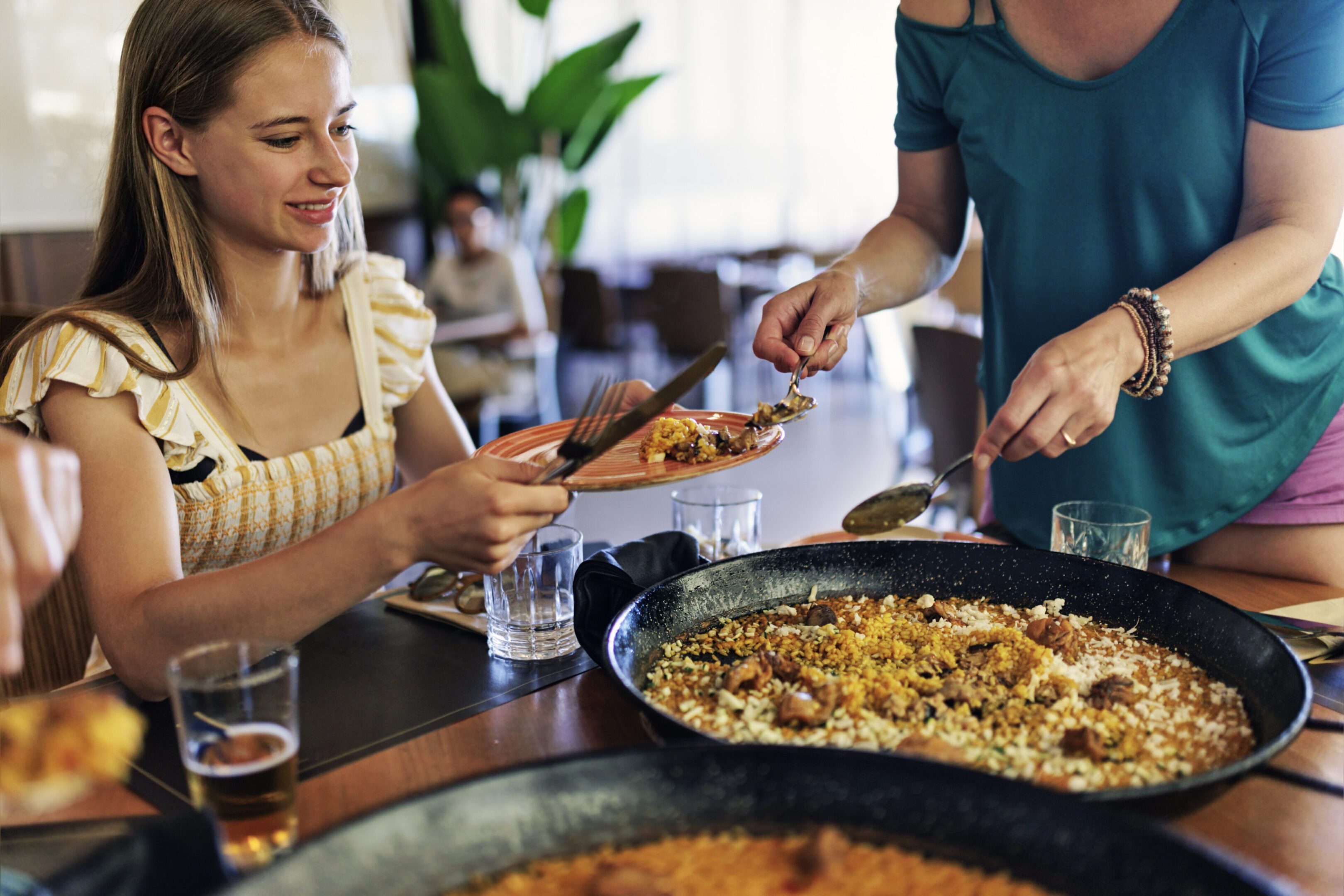 Mother and daughter having delicious paella dinner.
Canon R5