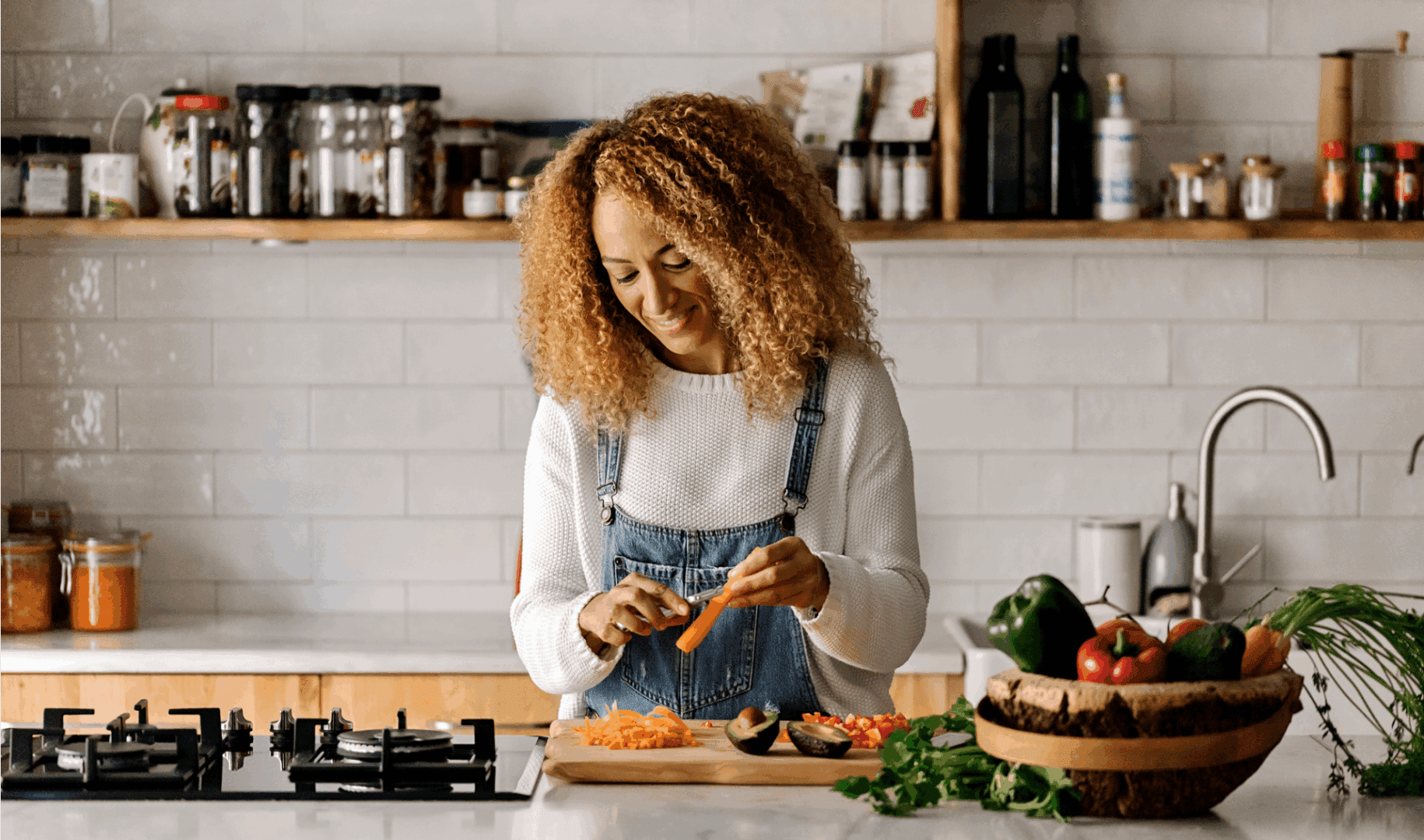 Woman chopping vegetables in a modern kitchen.