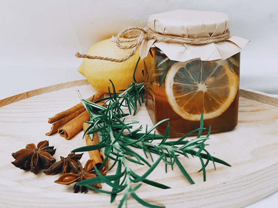 Jar with lemon, herbs, and spices arrangement.