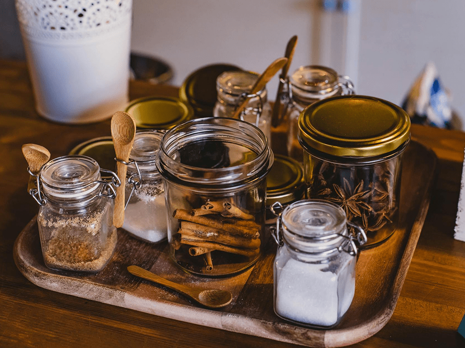 Jars of spices and sugar on tray.